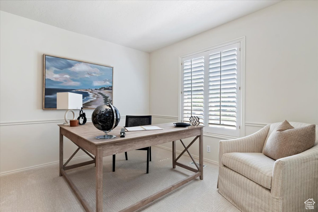 Home office featuring light carpet and baseboards