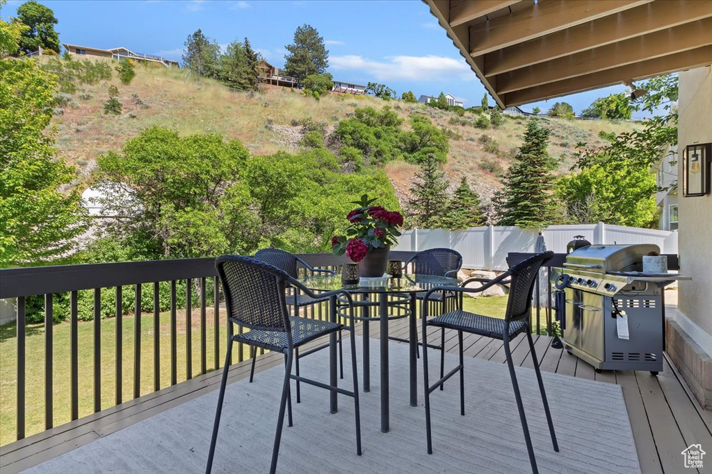Deck with a grill and outdoor dining area