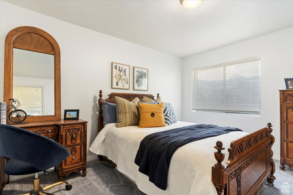 Bedroom with carpet flooring and baseboards