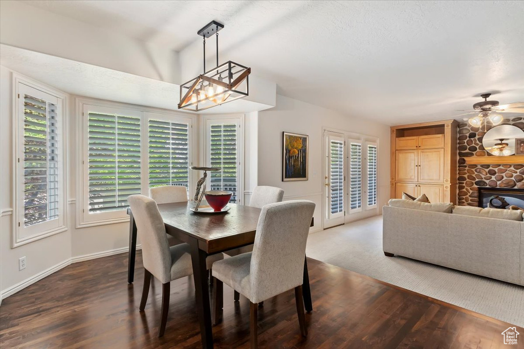 Dining area with dark wood-type flooring, plenty of natural light, and ceiling fan