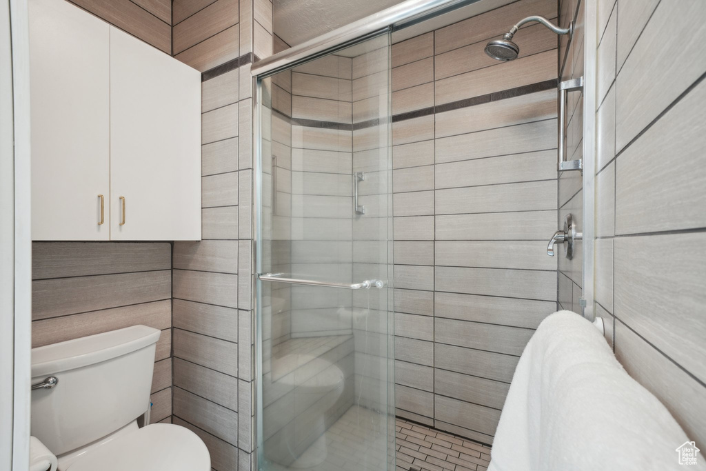 Bathroom featuring a stall shower and toilet