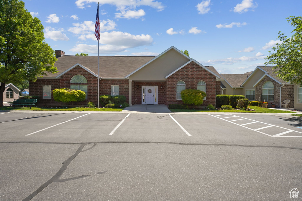 View of building exterior featuring uncovered parking