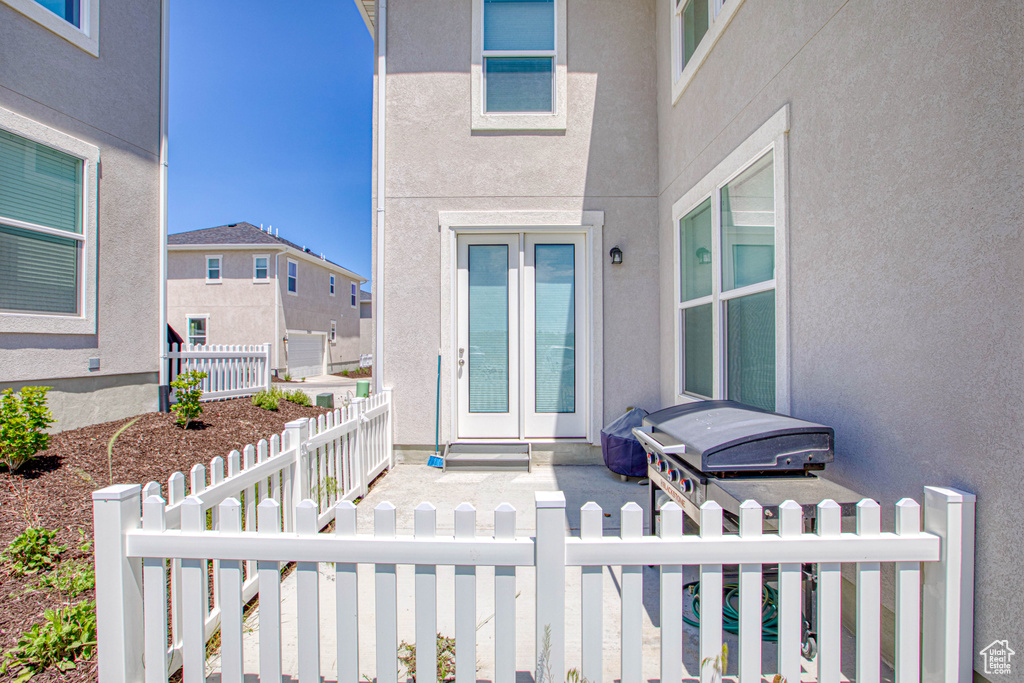 Entrance to property with stucco siding and a residential view