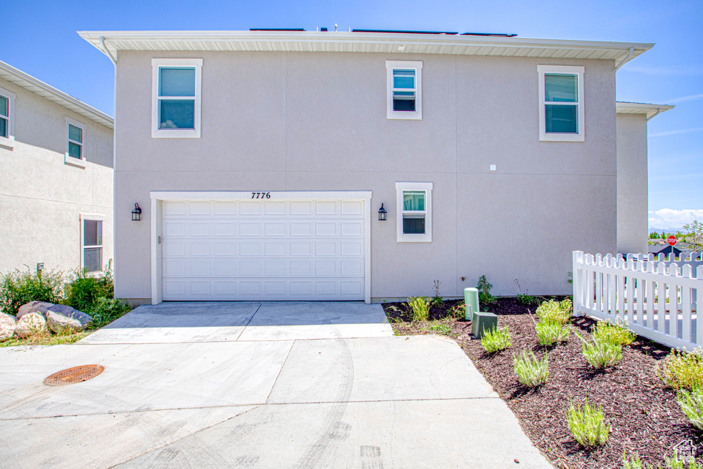 View of home's exterior featuring stucco siding and driveway