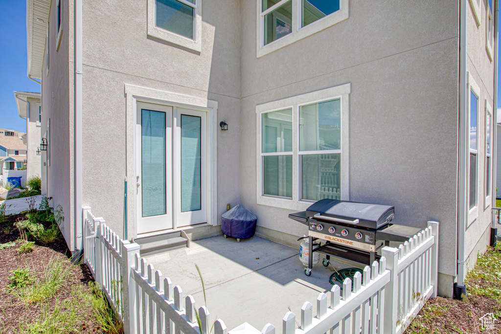 Property entrance with a patio area and stucco siding