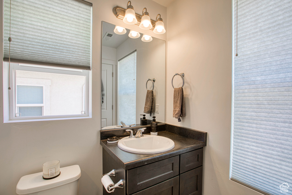 Half bath featuring vanity and toilet