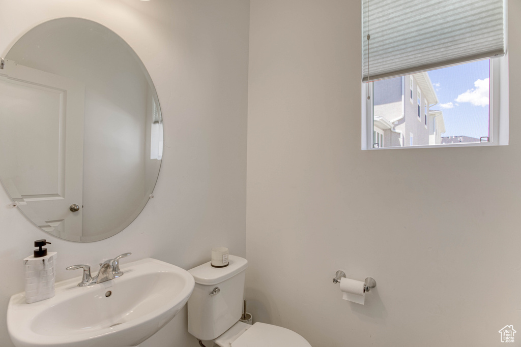 Half bathroom featuring a sink and toilet