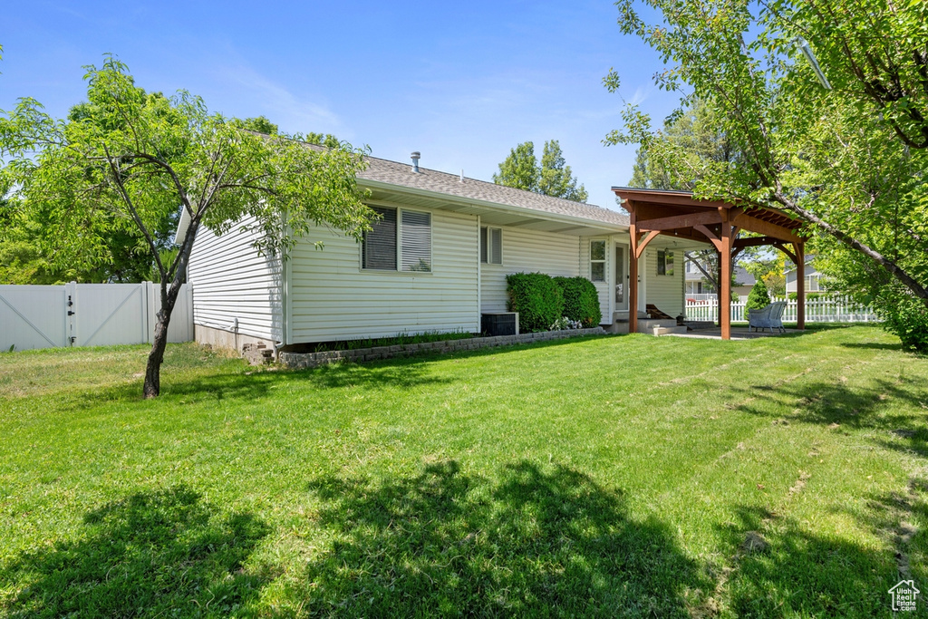 Back of property with a gate and central air condition unit