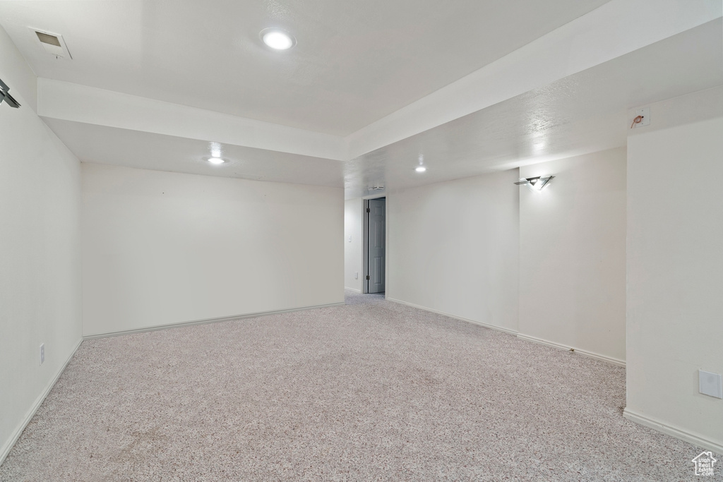 Finished basement with recessed lighting, light colored carpet, and baseboards