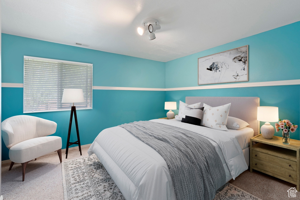 Carpeted bedroom featuring baseboards