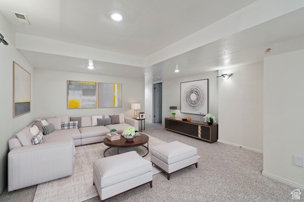 Carpeted living room with recessed lighting and baseboards