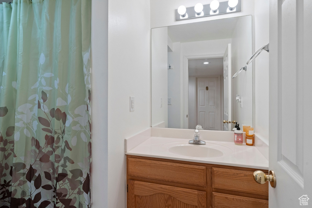 Full bath featuring vanity and a shower with shower curtain
