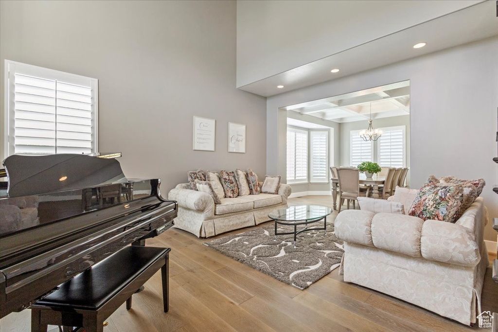 Living area featuring a chandelier, wood finished floors, recessed lighting, and beam ceiling