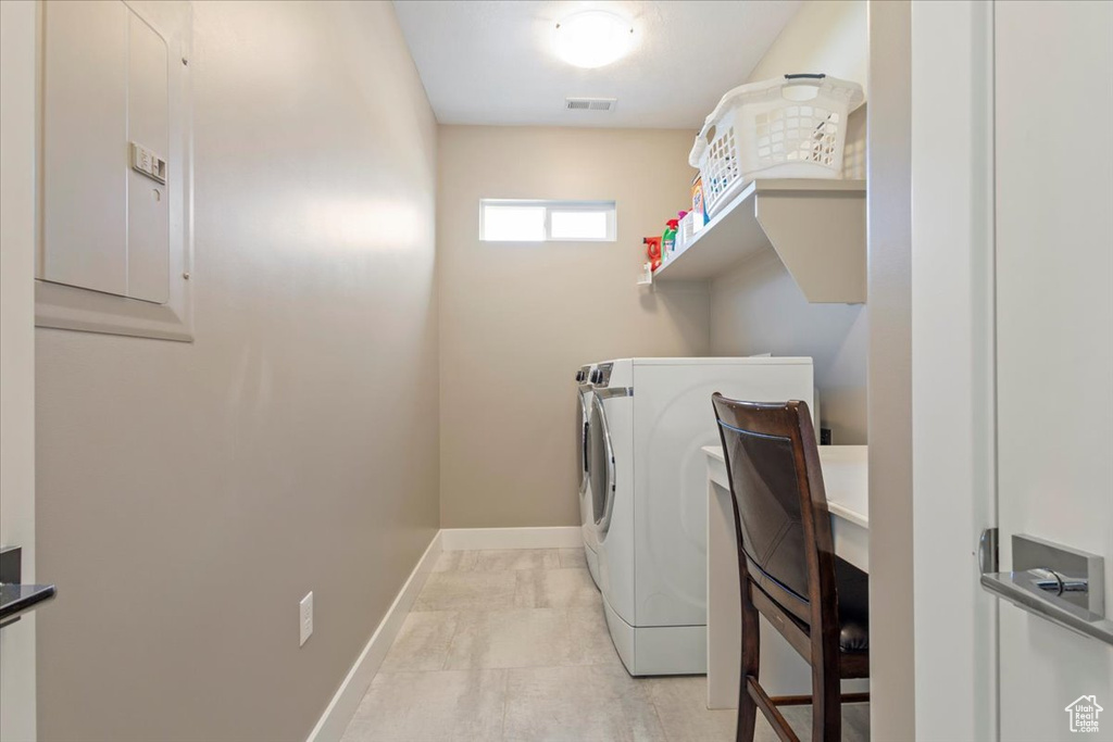 Laundry area featuring washing machine and clothes dryer and baseboards