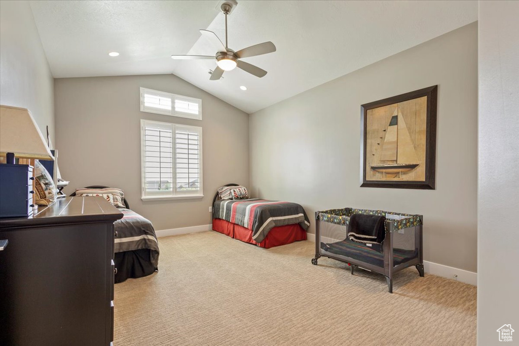 Bedroom featuring vaulted ceiling, carpet floors, baseboards, and ceiling fan
