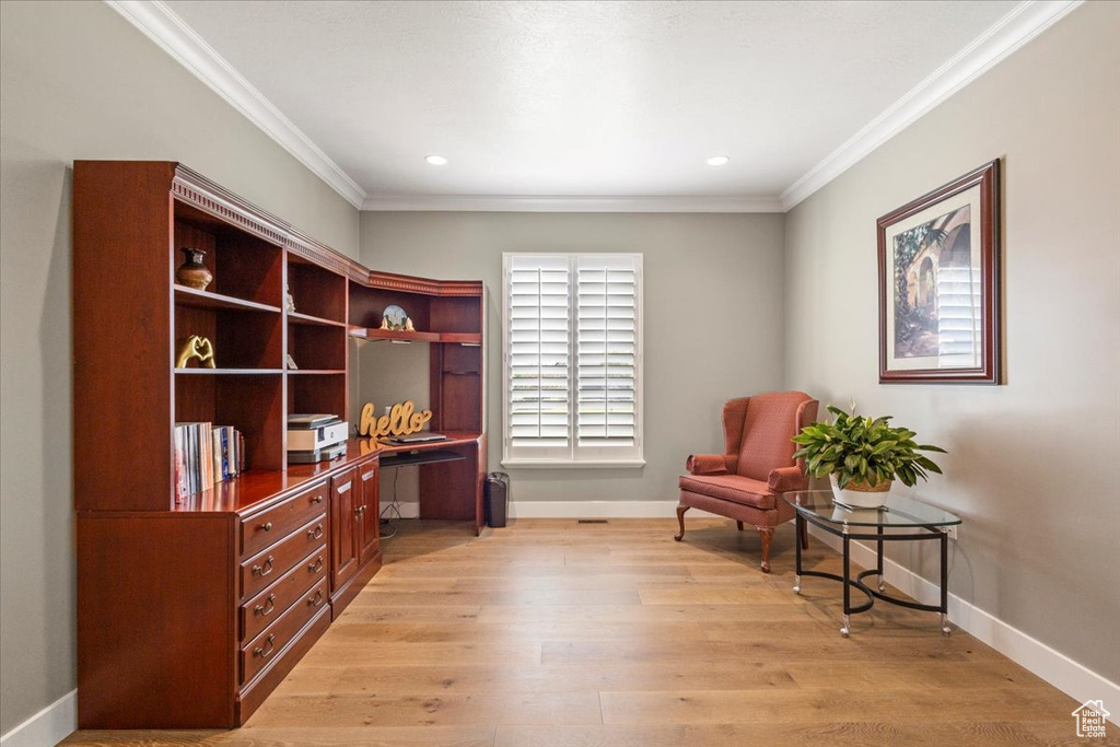 Sitting room featuring ornamental molding, an office area, baseboards, light wood finished floors, and recessed lighting