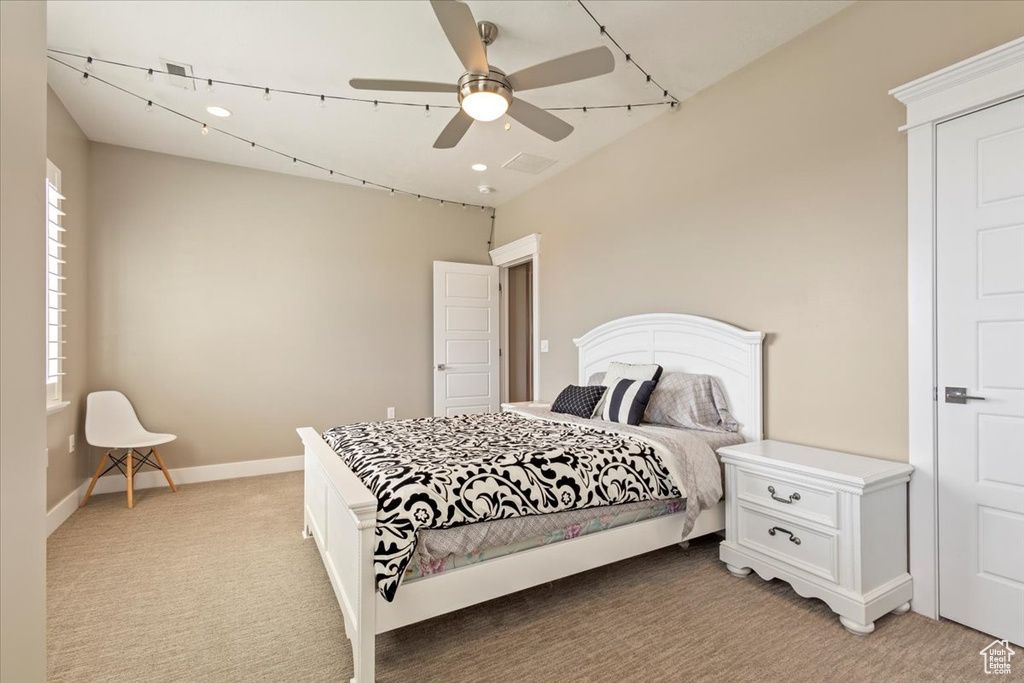 Bedroom with light carpet, baseboards, and ceiling fan