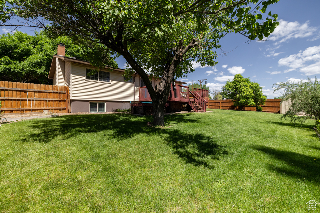 View of yard featuring stairway and a wooden deck