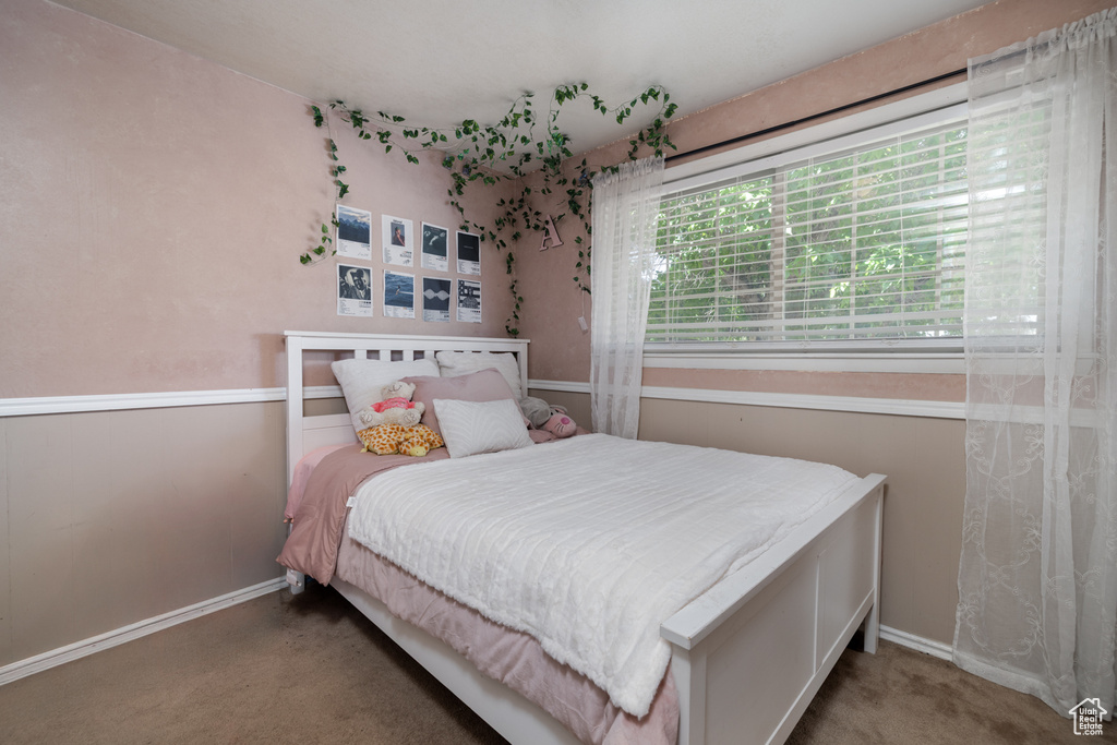 Carpeted bedroom featuring baseboards