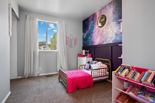 Carpeted bedroom with baseboards