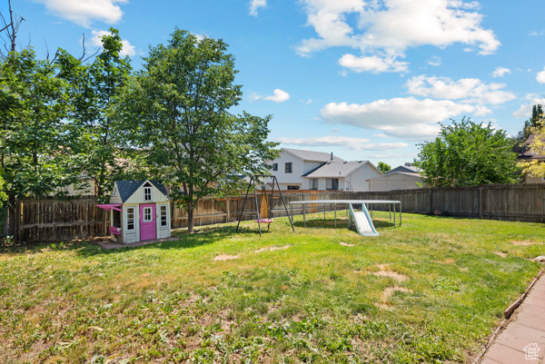 View of yard with a trampoline