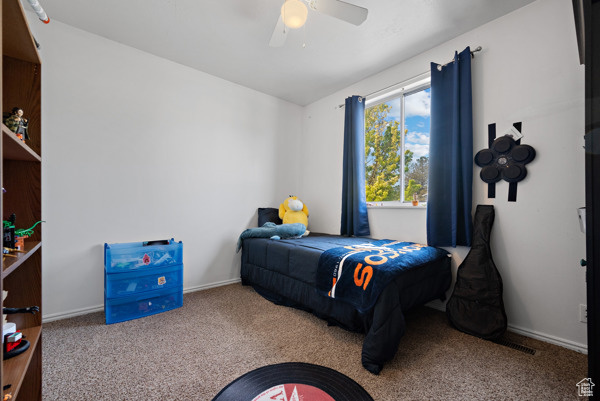 Bedroom featuring carpet flooring, a ceiling fan, and baseboards