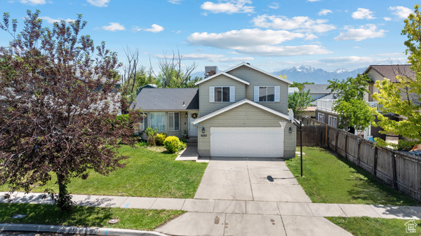 Tri-level home featuring driveway and a garage