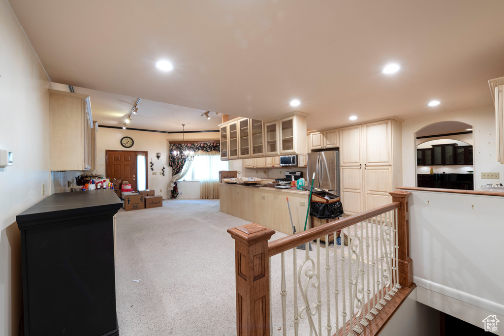 Kitchen with freestanding refrigerator, glass insert cabinets, rail lighting, light carpet, and recessed lighting