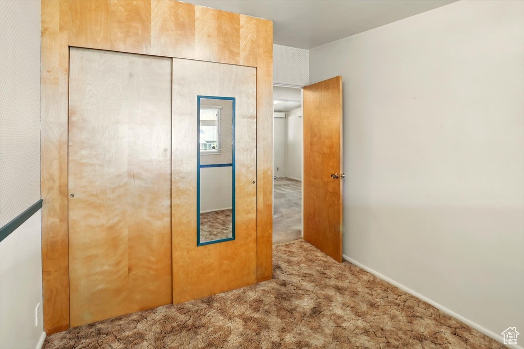 Unfurnished bedroom featuring carpet floors and a closet