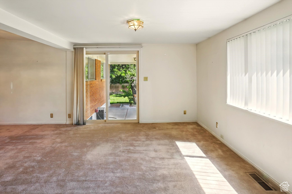Empty room with carpet flooring and baseboards
