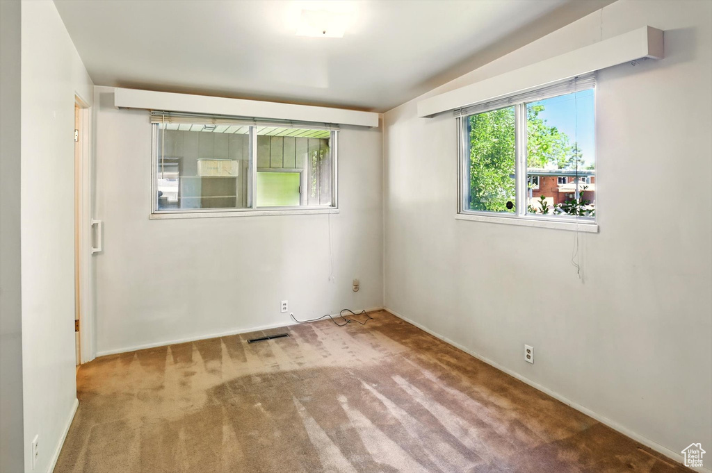 Carpeted empty room with baseboards