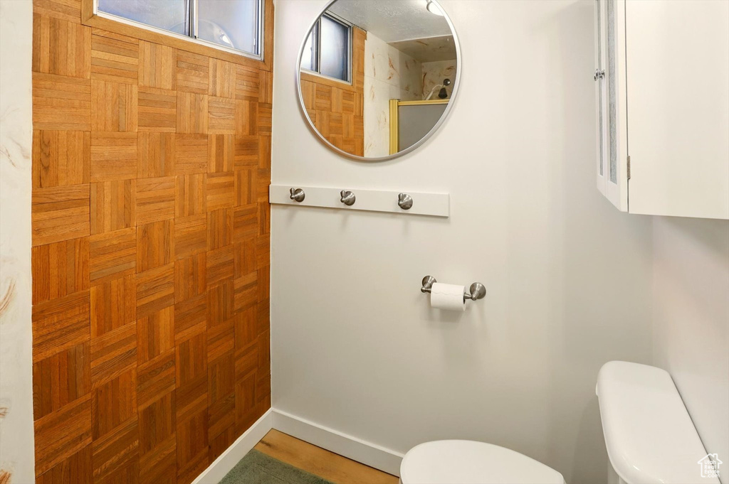 Bathroom featuring toilet, baseboards, and a shower