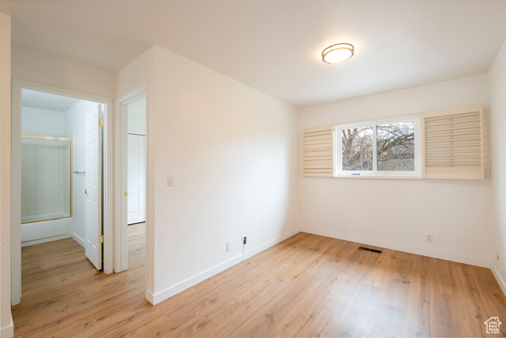 Spare room featuring light wood finished floors and baseboards