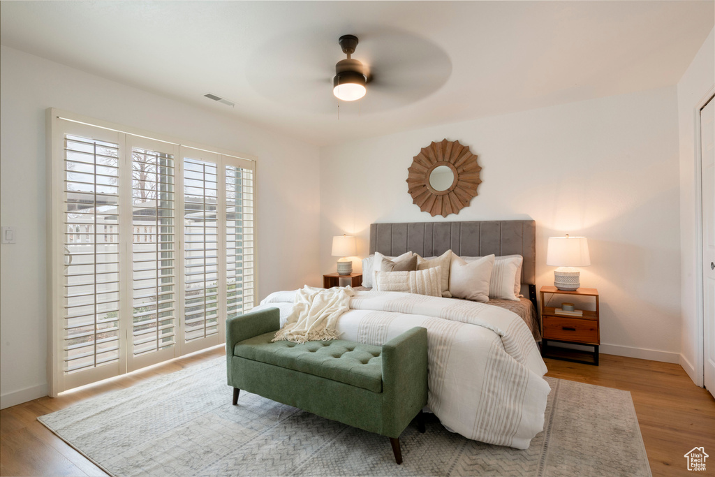 Bedroom featuring wood finished floors, baseboards, and a ceiling fan