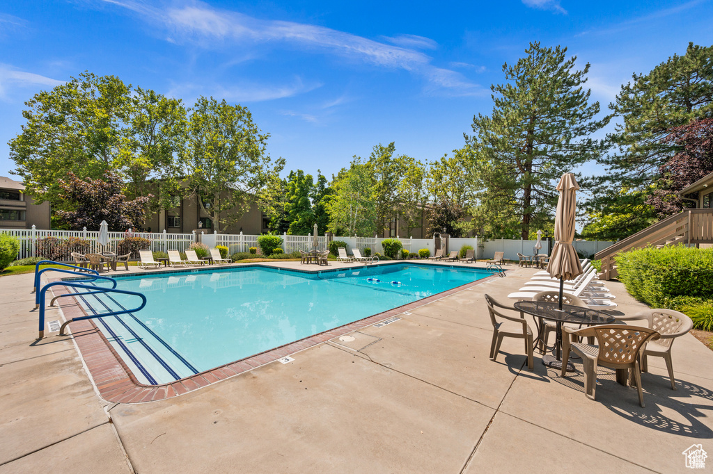 Community pool featuring a patio