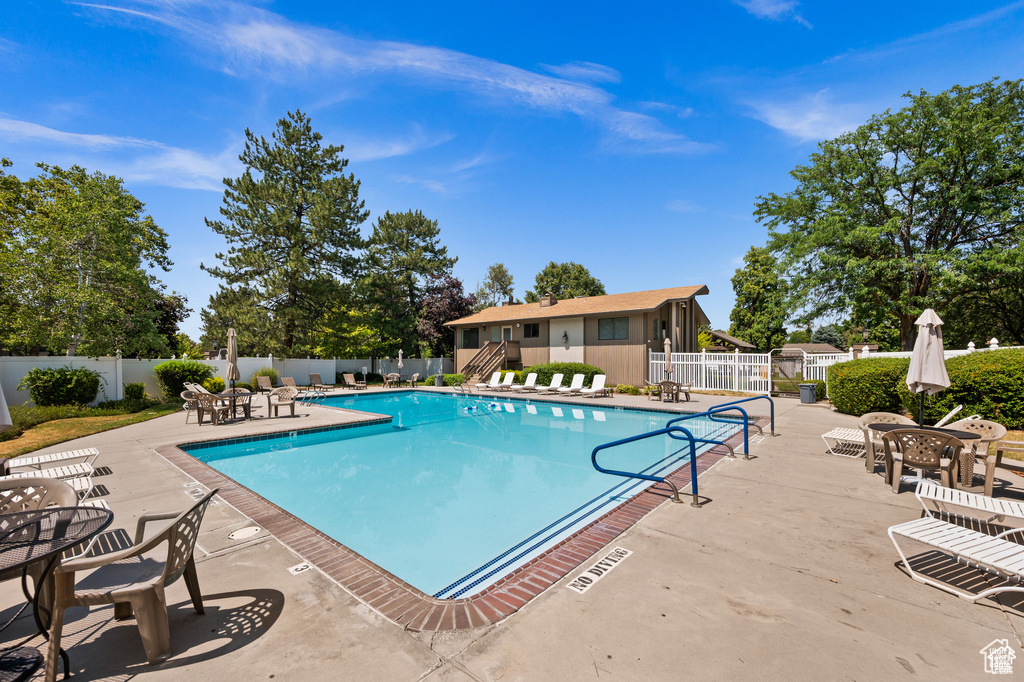 Community pool with a patio