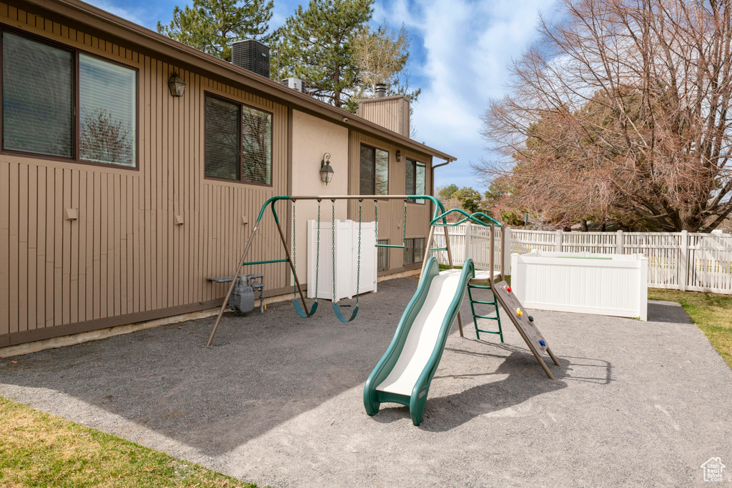 View of jungle gym featuring central air condition unit