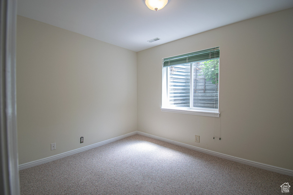 Empty room with carpet and baseboards