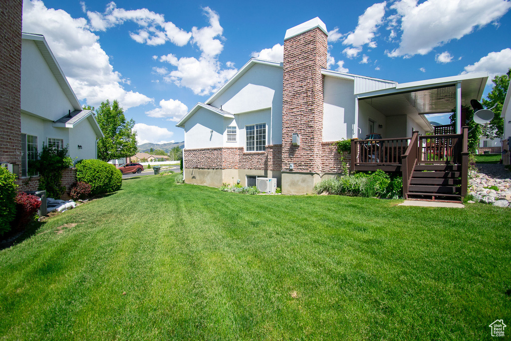 View of green lawn with a deck