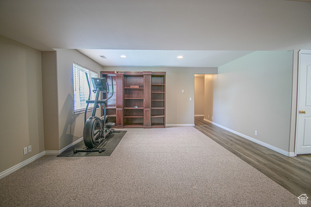 Workout area featuring recessed lighting, baseboards, and wood finished floors