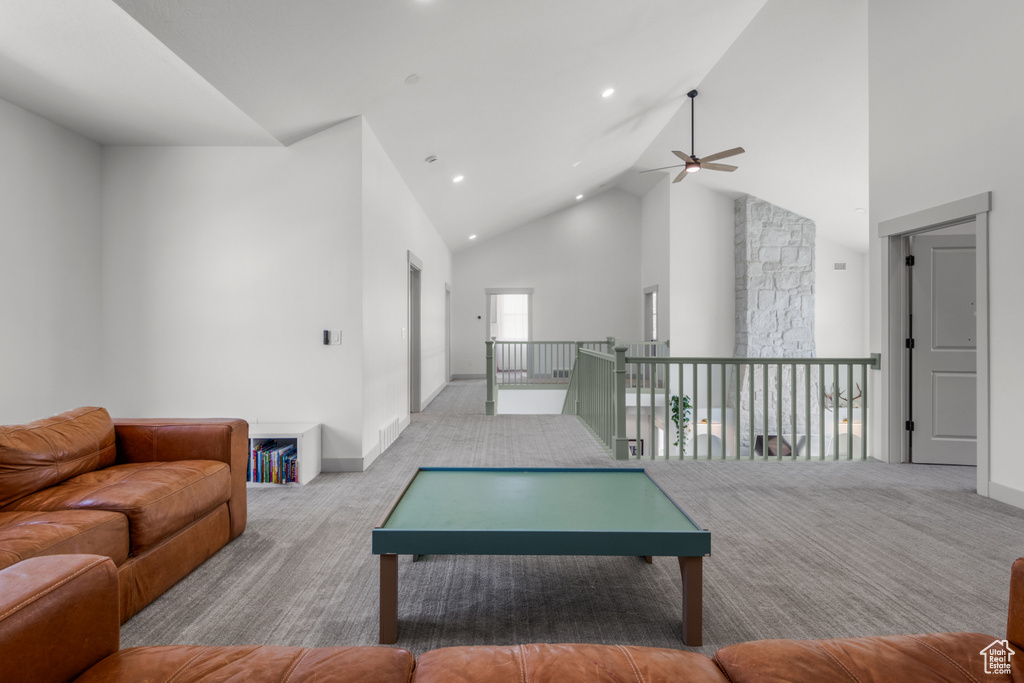 Living area featuring ceiling fan, carpet, high vaulted ceiling, recessed lighting, and baseboards