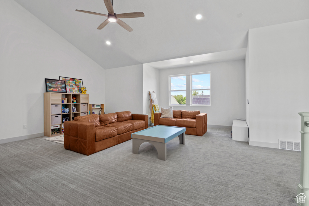 Living room with light carpet, ceiling fan, recessed lighting, lofted ceiling, and baseboards