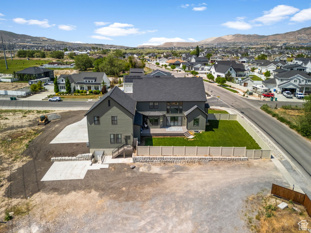 Aerial view of residential area featuring a mountainous background