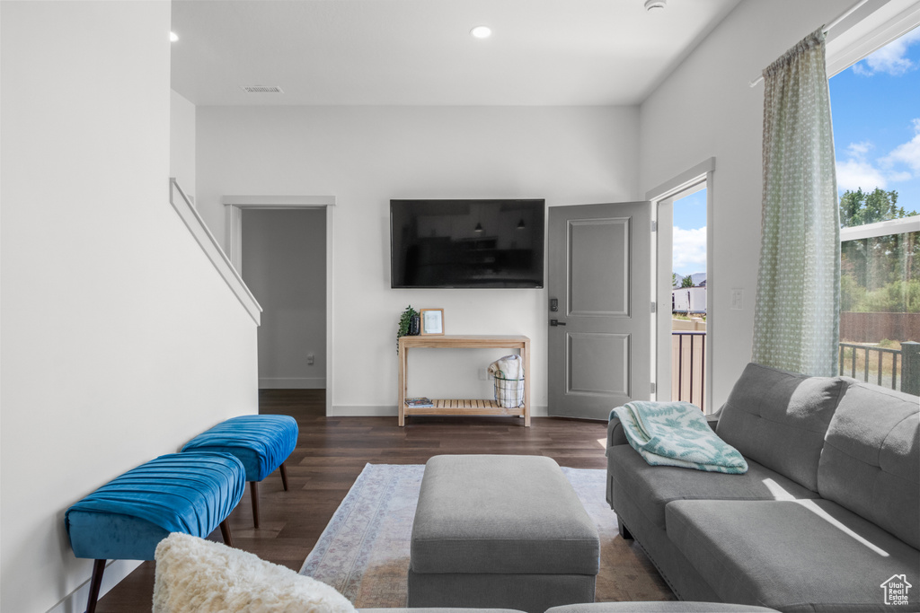 Living area featuring wood finished floors, recessed lighting, and baseboards