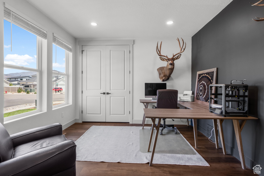 Office space featuring wood finished floors and recessed lighting