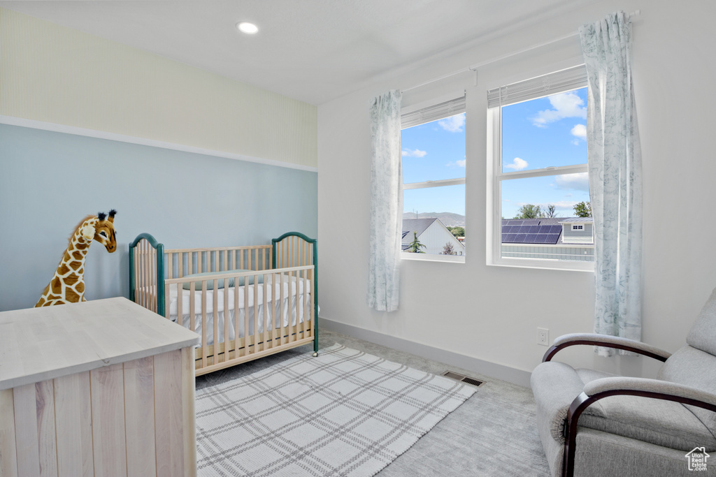 Bedroom with a nursery area, baseboards, carpet floors, and recessed lighting