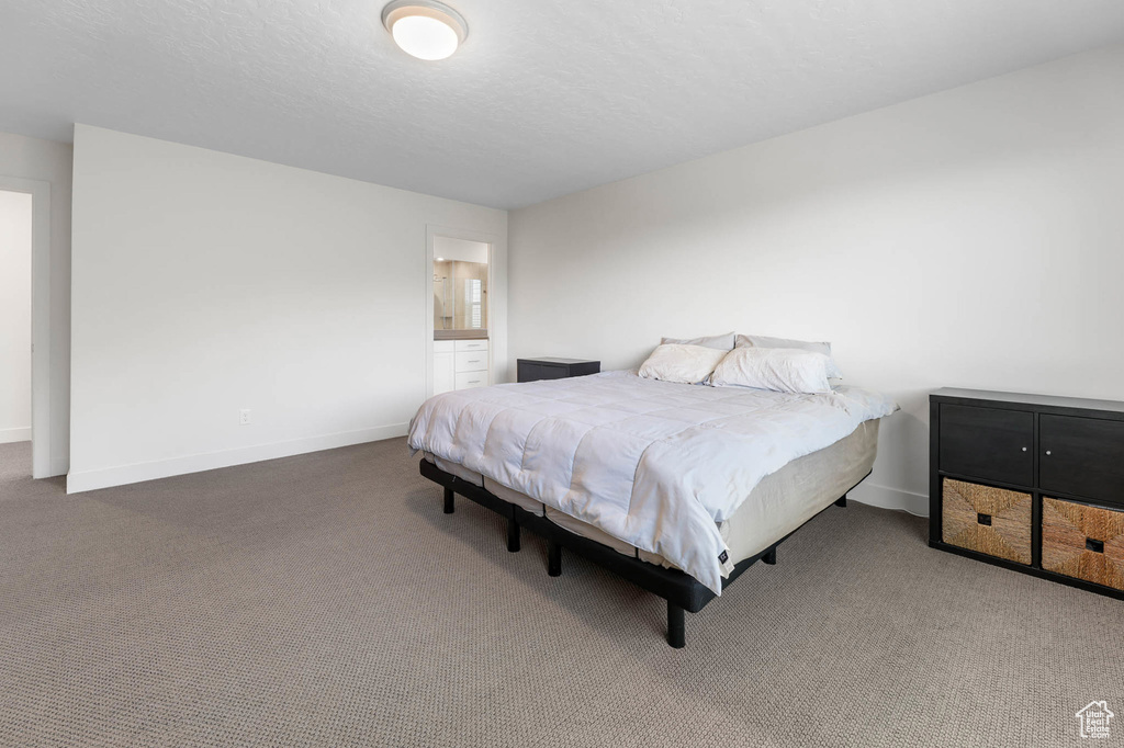 Carpeted bedroom featuring baseboards