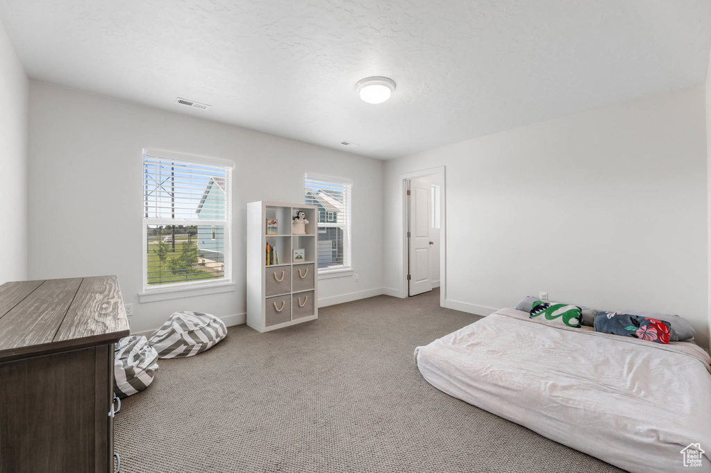 Carpeted bedroom with baseboards