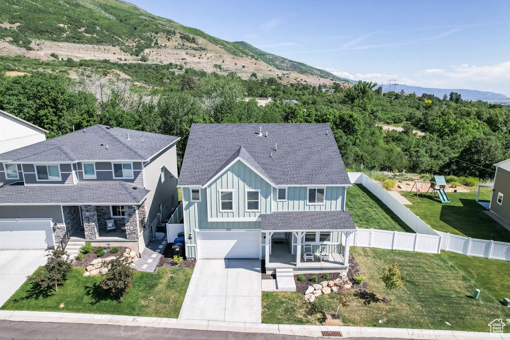 Aerial view of property and surrounding area with mountains