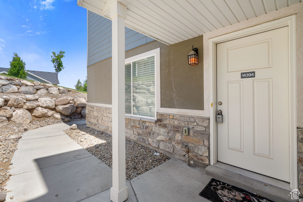 View of exterior entry featuring stone siding